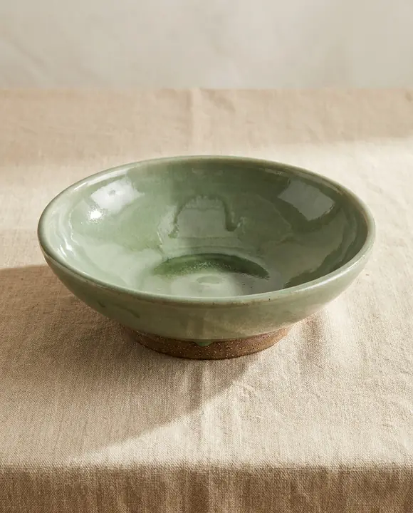 Wide ceramic bowl with a glossy sage-green celadon glaze